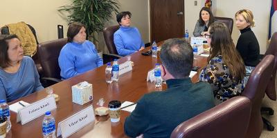 DeGette meets at a table with 3 women